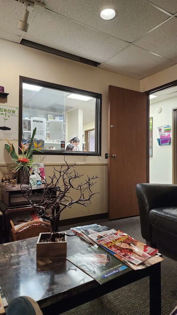 Front desk check-in window in Dr. Shamani's office, with a magazine table and seating in the waiting area