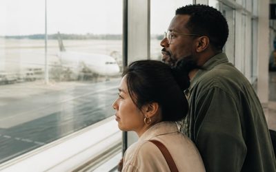 Couple watching planes from an airport window